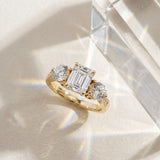 Yellow gold Three-Stone Emerald Diamond Engagement Ring with Prong Setting on a Classic Band_6
