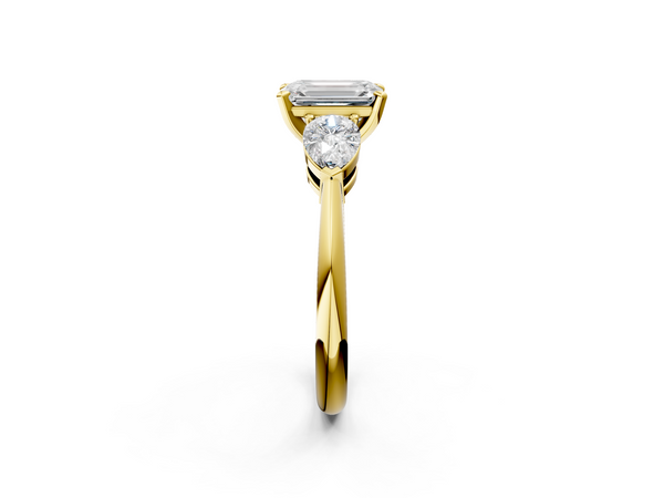 Yellow gold Three-Stone Emerald Cut Diamond Ring with Pear Side Stones and Four-Prong Setting