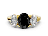 Yellow gold Three-Stone Fancy Black Oval Cut Cut Diamond Ring with Channel Set Band and Four-Prong Setting