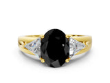 Yellow gold Three-Stone Fancy Black Oval Cut Cut Diamond Ring with Trillion Side Stones on a Split Shank Band