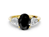 Yellow gold Three-Stone Fancy Black Oval Cut Diamond Ring with Pear Side Stones and Four-Prong Setting