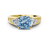 Yellow gold Three-Stone Fancy Blue Cushion Cut Cut Diamond Ring with Trillion Side Stones on a Split Shank Band