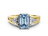 Yellow gold Three-Stone Fancy Blue Emerald Cut Cut Diamond Ring with Trillion Side Stones on a Split Shank Band