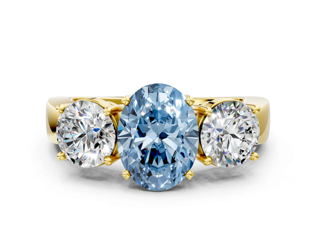 Yellow gold Three-Stone Fancy Blue Oval Cut Diamond Ring with Round Side Stones, Classic Band, and Four-Prong Setting