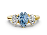 Yellow gold Three-Stone Fancy Blue Pear Cut Cut Diamond Ring with Channel Set Band and Four-Prong Setting