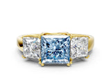Yellow gold Three-Stone Fancy Blue Princess Cut Cut Diamond Ring with Channel Set Band and Four-Prong Setting