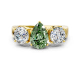Yellow gold Three-Stone Fancy Green Pear Cut Diamond Ring with Round Side Stones, Classic Band, and Four-Prong Setting