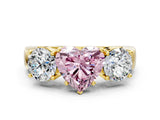 Yellow gold Three-Stone Fancy Pink Heart Cut Diamond Ring with Round Side Stones, Classic Band, and Four-Prong Setting
