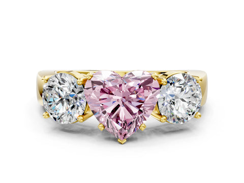 Yellow gold Three-Stone Fancy Pink Heart Cut Diamond Ring with Round Side Stones, Classic Band, and Four-Prong Setting