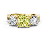 Yellow gold Three-Stone Fancy Yellow Cushion Cut Diamond Ring with Round Side Stones, Classic Band, and Four-Prong Setting