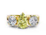 Yellow gold Three-Stone Fancy Yellow Pear Cut Diamond Ring with Round Side Stones, Classic Band, and Four-Prong Setting