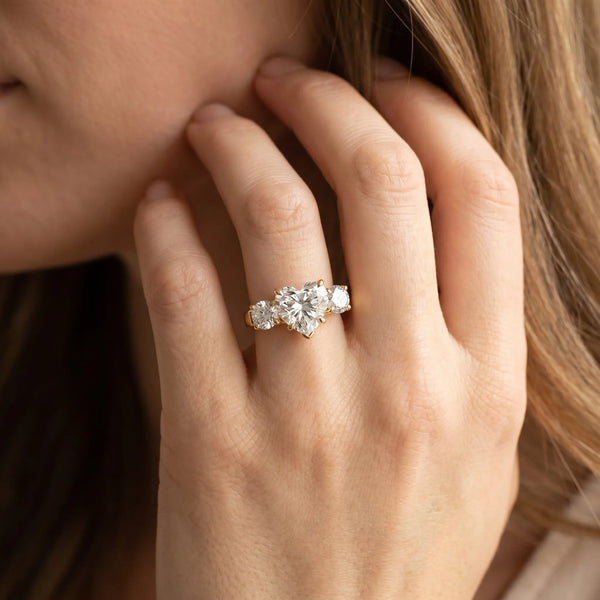 Yellow gold Three-Stone Heart Cut Diamond Ring with Round Accent Stones, Prong Setting, and Classic Band