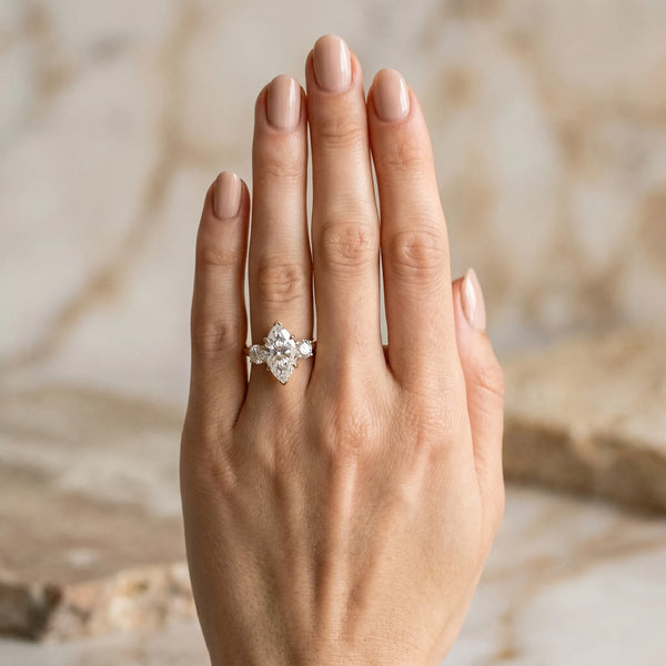 Yellow gold Three-Stone Marquise Cut Diamond Engagement Ring with Prong Setting on a White Gold Band