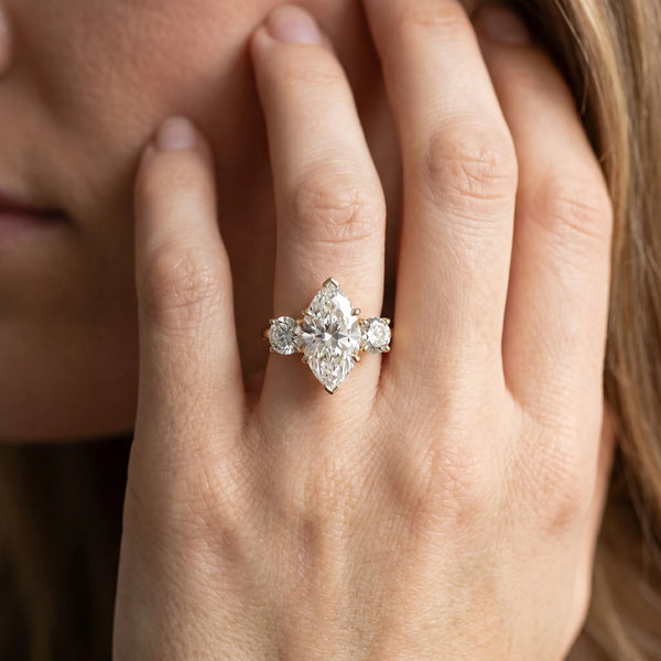 Yellow gold Three-Stone Marquise Cut Diamond Engagement Ring with Prong Setting on a White Gold Band