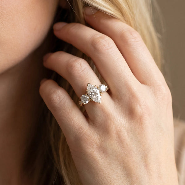 Yellow gold Three-Stone Marquise Diamond Engagement Ring with Prong Setting on a Classic Band