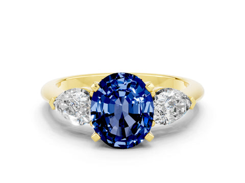 Yellow gold Three-Stone Oval Cut Blue Sapphire Ring with Pear Side Stones and Four-Prong Setting