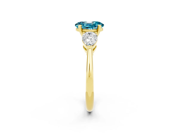 Yellow gold Three-Stone Oval Cut Blue Topaz Ring with Pear Side Stones and Four-Prong Setting