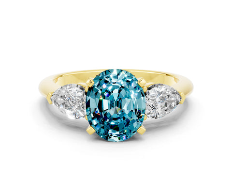 Yellow gold Three-Stone Oval Cut Blue Topaz Ring with Pear Side Stones and Four-Prong Setting