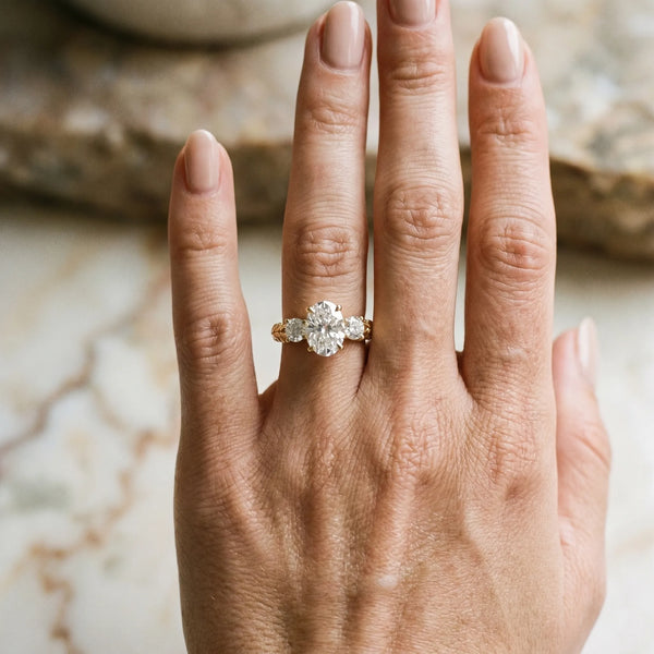 Yellow gold Three-Stone Oval Cut Diamond Ring with Channel-Set Band and Prong Setting