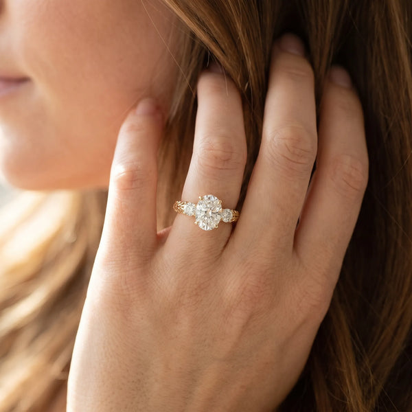 Yellow gold Three-Stone Oval Cut Diamond Ring with Channel-Set Band and Prong Setting