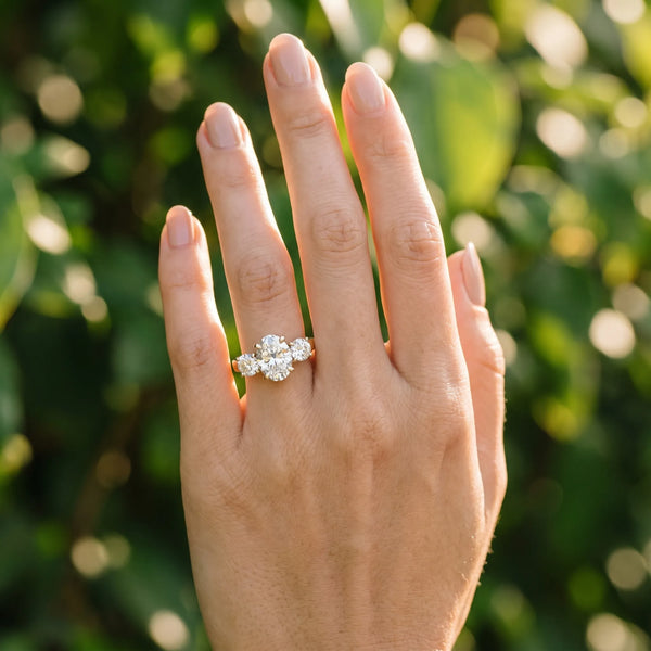 18K Yellow Gold Three-Stone 2.03 Carat E VVS1 Oval Cut Diamond Ring with Round Accent Stones, Prong Setting, and Classic Band