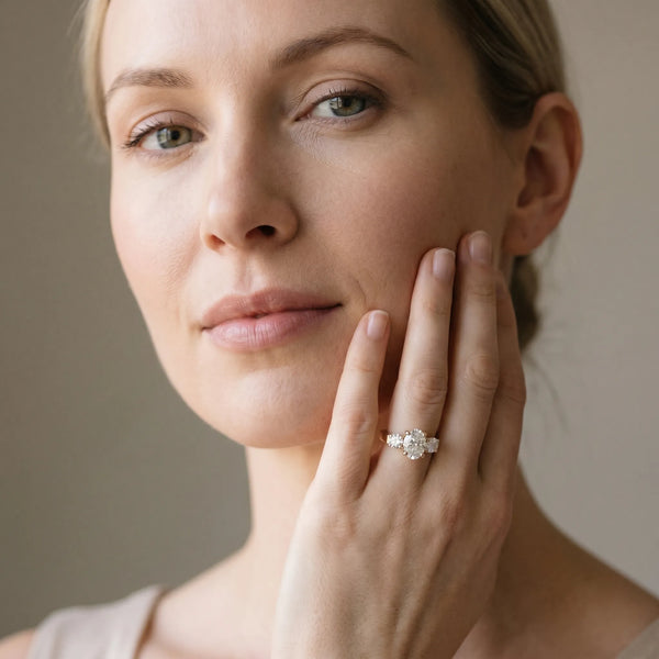 Yellow gold Three-Stone Oval Cut Diamond Ring with Round Accent Stones, Prong Setting, and Classic Band