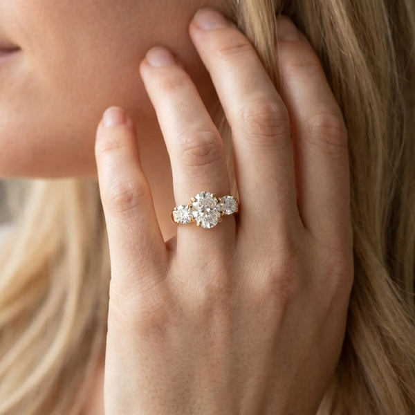 18K Yellow Gold Three-Stone 2.03 Carat E VVS1 Oval Cut Diamond Ring with Round Accent Stones, Prong Setting, and Classic Band