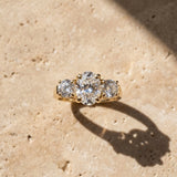 Yellow gold Three-Stone Oval Cut Diamond Ring with Round Accent Stones, Prong Setting, and Classic Band_50