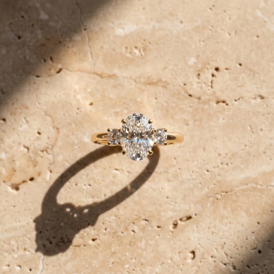 Yellow gold Three-Stone Oval Cut Diamond Solitaire with Prong Setting and Classic Band