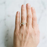 Yellow gold Three-Stone Oval Diamond Ring with Round Side Stones, Classic Band, and Four-Prong Setting