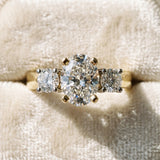 Yellow gold Three-Stone Oval Diamond Ring with Round Side Stones, Classic Band, and Four-Prong Setting