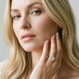 Yellow gold Three-Stone Oval Diamond Ring with Round Side Stones, Classic Band, and Four-Prong Setting