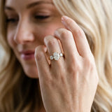 Yellow gold Three-Stone Oval Diamond Ring with Round Side Stones, Classic Band, and Four-Prong Setting