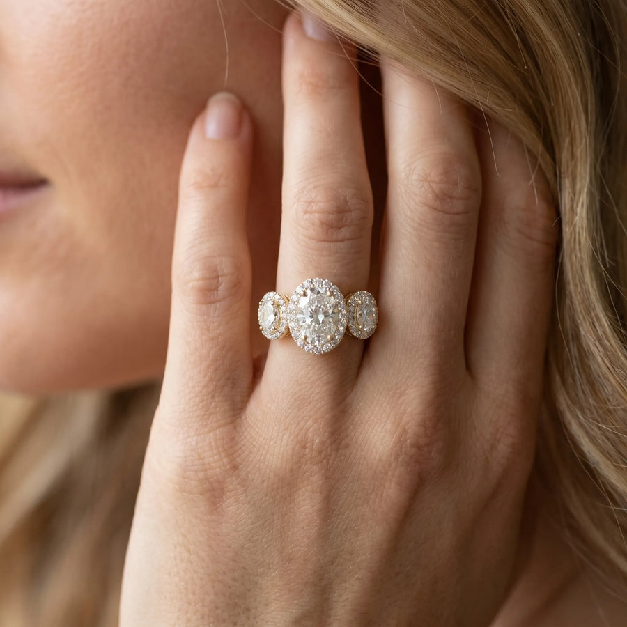 Yellow gold Three-Stone Oval Halo Diamond Ring with Pave Band and Four-Prong Setting