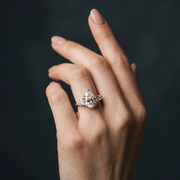 Yellow gold Three-Stone Pear Cut Diamond Ring with Channel Set Band and Four-Prong Setting