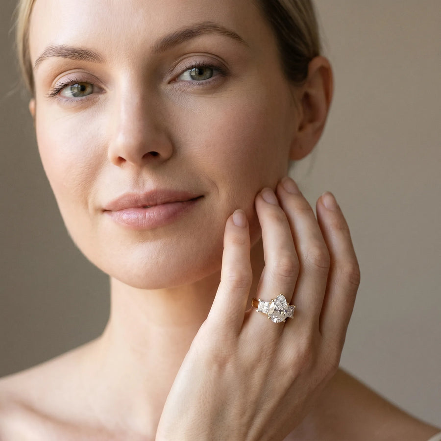 Yellow gold Three-Stone Pear Cut Diamond Ring with Channel Set Band and Four-Prong Setting