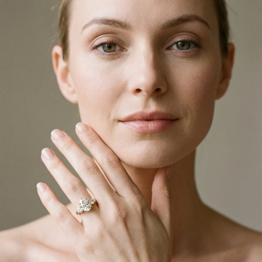 Yellow gold Three-Stone Pear Cut Diamond Ring with Round Accent Stones, Prong Setting, and Classic Band
