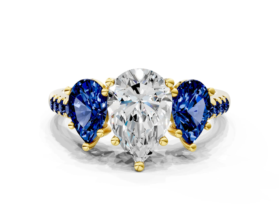 Yellow gold Three-Stone Pear Cut Diamond Ring with Round with Blue Sapphire side stone Pavé Band and Prong Setting