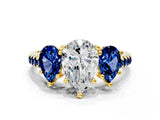 Yellow gold Three-Stone Pear Cut Diamond Ring with Round with Blue Sapphire side stone Pavé Band and Prong Setting