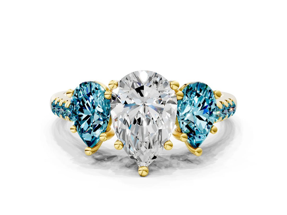 Yellow gold Three-Stone Pear Cut Diamond Ring with Round with Blue Topaz side stone Pavé Band and Prong Setting