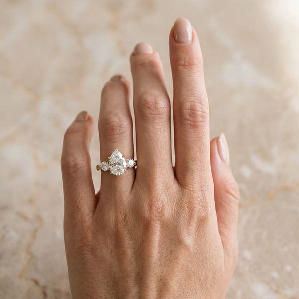 Yellow gold Three-Stone Pear Diamond Engagement Ring with Prong Setting on a Classic Band