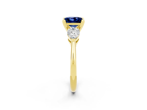 Yellow gold Three-Stone Princess Cut Blue Sapphire Ring with Pear Side Stones and Four-Prong Setting