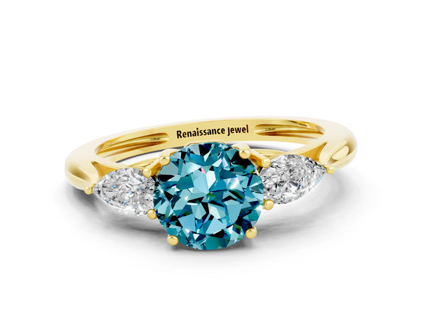 Yellow gold Three-Stone Round Cut Blue Topaz Ring with Pear  Side Stones in Four-Prong Setting