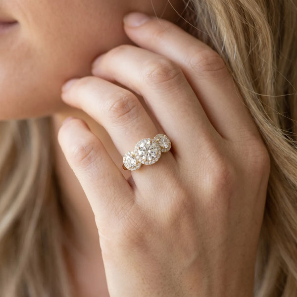 Yellow gold Three-Stone Round Halo Diamond Ring with Pavé Band and Prong Setting