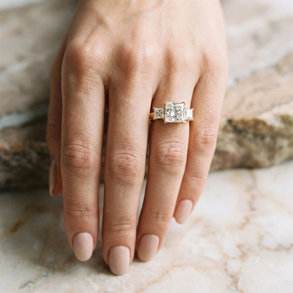 Yellow gold Three-Stone Round and Princess Cut Diamond Ring with Channel Band and Four-Prong Setting