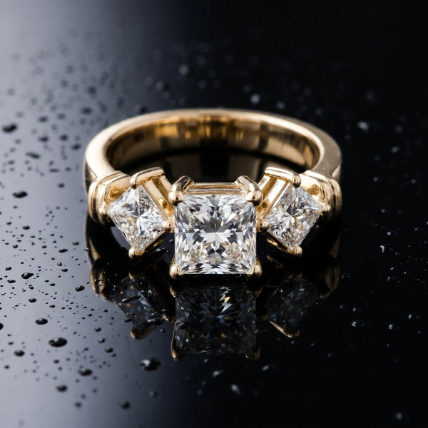 Yellow gold Three-Stone Round and Princess Cut Diamond Ring with Channel Band and Four-Prong Setting