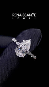 Silver Pear Cut Diamond Ring with Marquise and Round  Side Stones and Four-Prong Setting