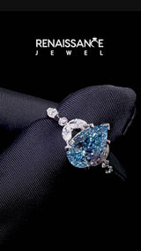 White gold Fancy Blue Pear Cut Diamond Solitaire Ring with Side Stones and Four-Prong Setting