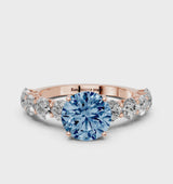 Rose gold Fancy Blue Round Cut Diamond Prong Setting with Side Stones on a Pave Band