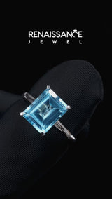 Silver Emerald Cut Blue Topaz Solitaire Engagement Ring with Round Band and Four-Prong Setting